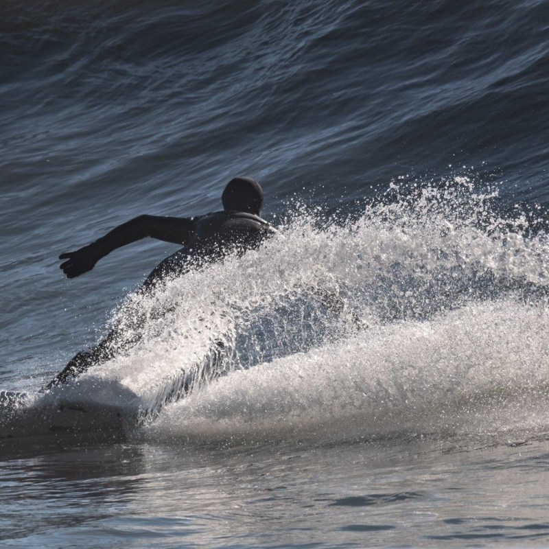 a man riding a wave on a surfboard in the ocean