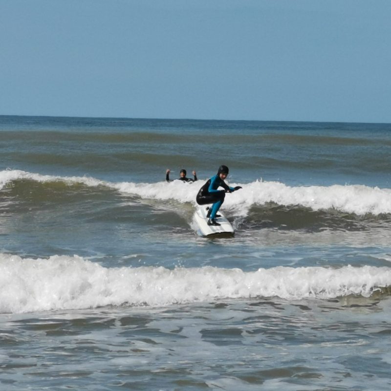 a man riding a wave on a surfboard in the ocean