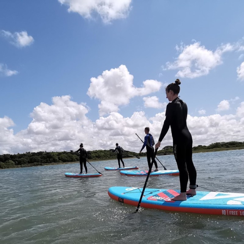 a man riding on the back of a boat in the water