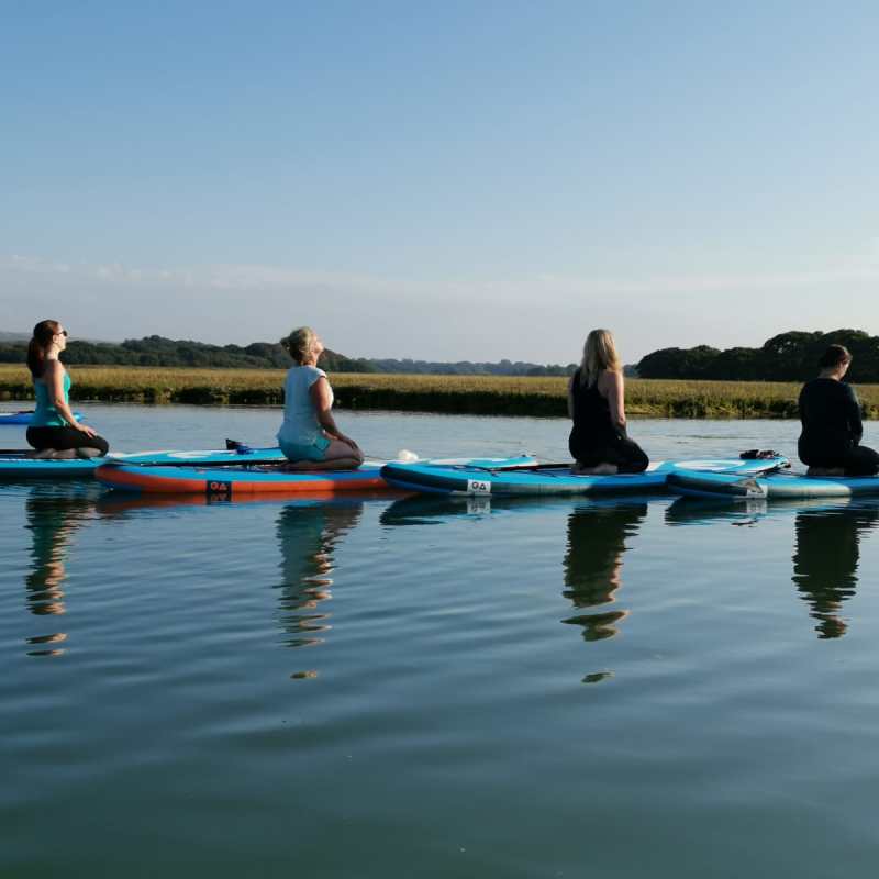 a group of people rowing a boat in the water