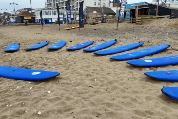a group of people standing on top of a sandy beach
