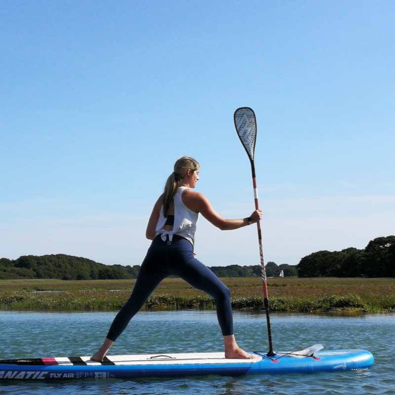 a person standing next to a body of water