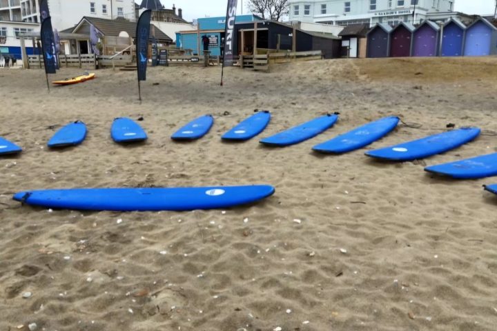 surfboards lined up on the beach