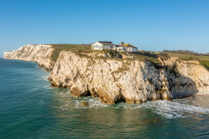 a rocky island in the middle of a body of water