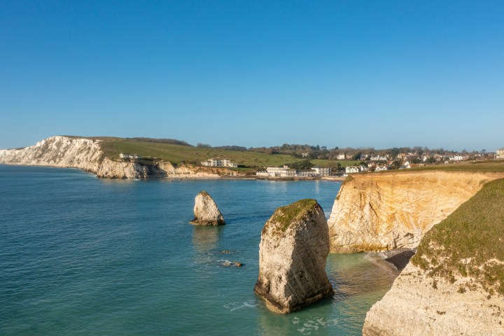 a rocky island in the middle of a body of water